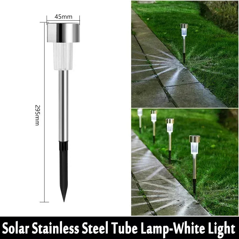 A vertical view of a solar stainless steel tube lamp with a white light, shown in a garden path context.