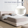 White bed sheet straps or clips used to secure and keep sheets tidy on a bed.