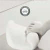 A hand is applying a white memory foam pillow to a person's neck and shoulder area.