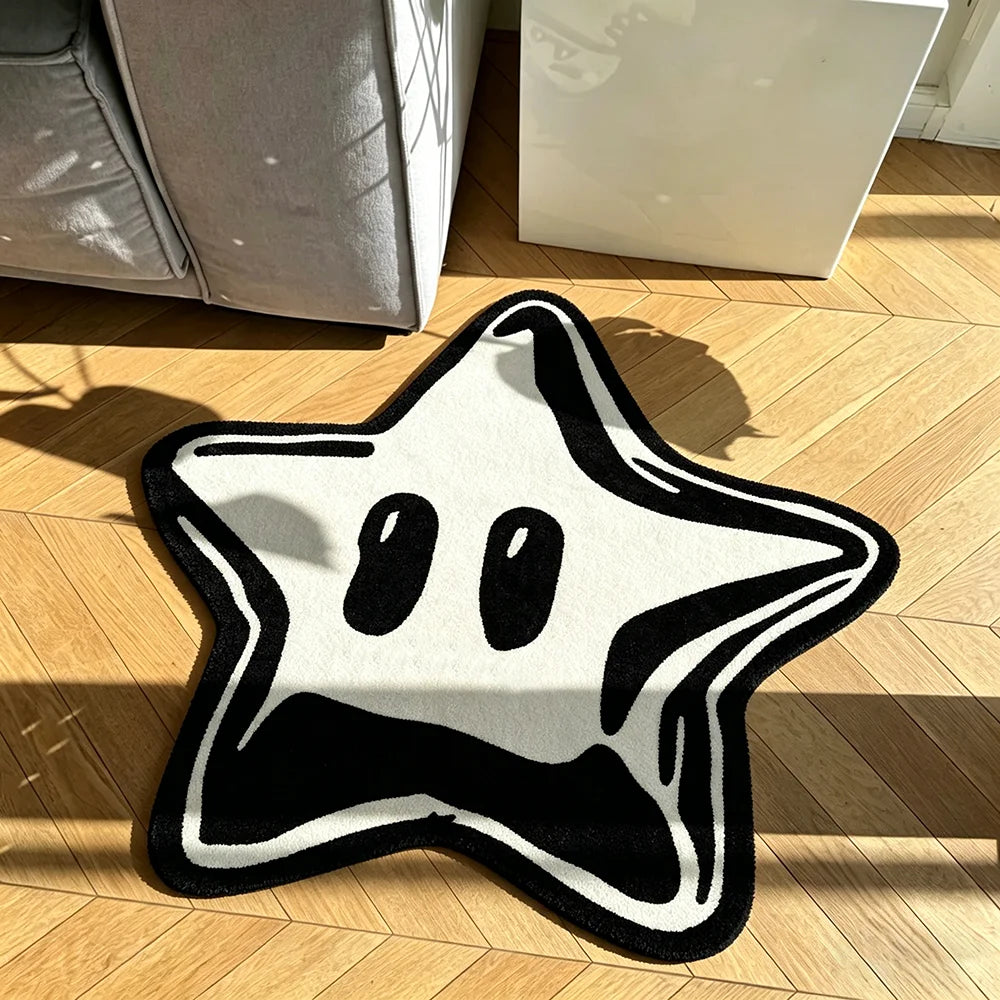 A black and white irregular pentagram rug placed on a wooden floor.