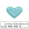 A light blue heart-shaped embroidered iron-on patch for clothing and crafts.