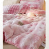 A pink and white checkered plush winter comforter or quilt with a fluffy texture.