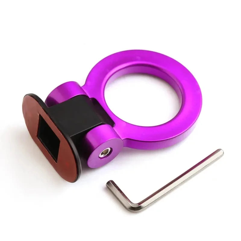A close-up of a purple and black sporty trailer hook decorative accent for cars.