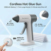 A cordless hot glue gun in white and gray is shown with a large nozzle, demonstrating its features.