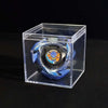 A Valkyrie Volt S4-70V metal spinning top is displayed inside a clear acrylic box.