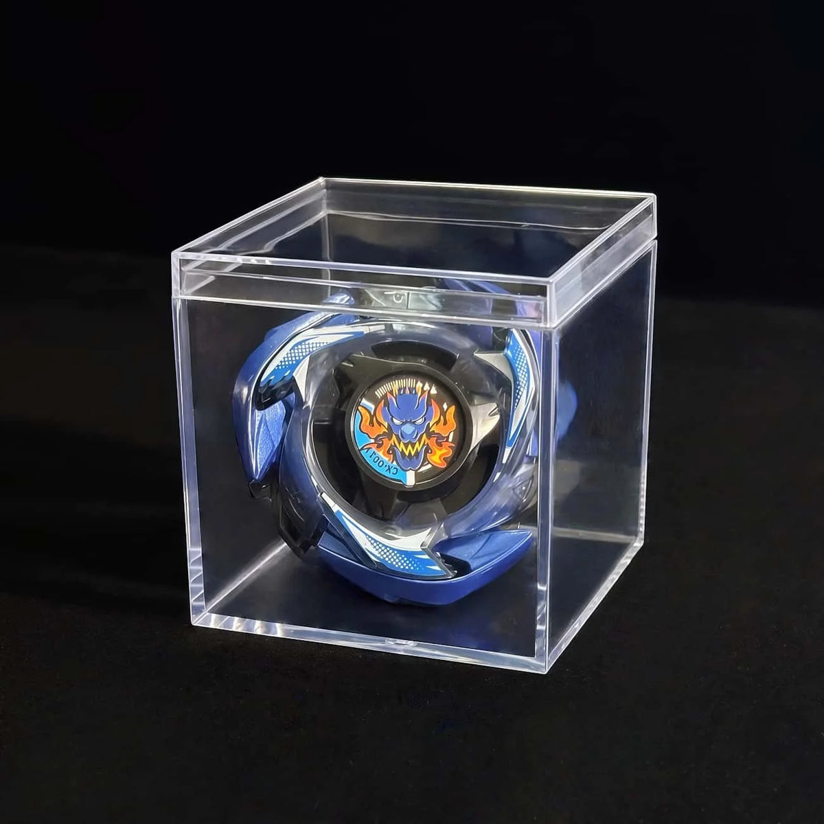 A Valkyrie Volt S4-70V metal spinning top is displayed inside a clear acrylic box.