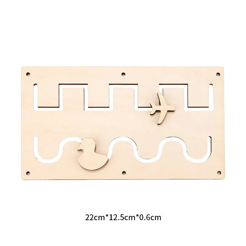 A light wood Montessori busy board featuring cutout shapes including an airplane and a duck.