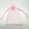 Pink organza drawstring bag with a sheer fabric tie and a decorative bow.