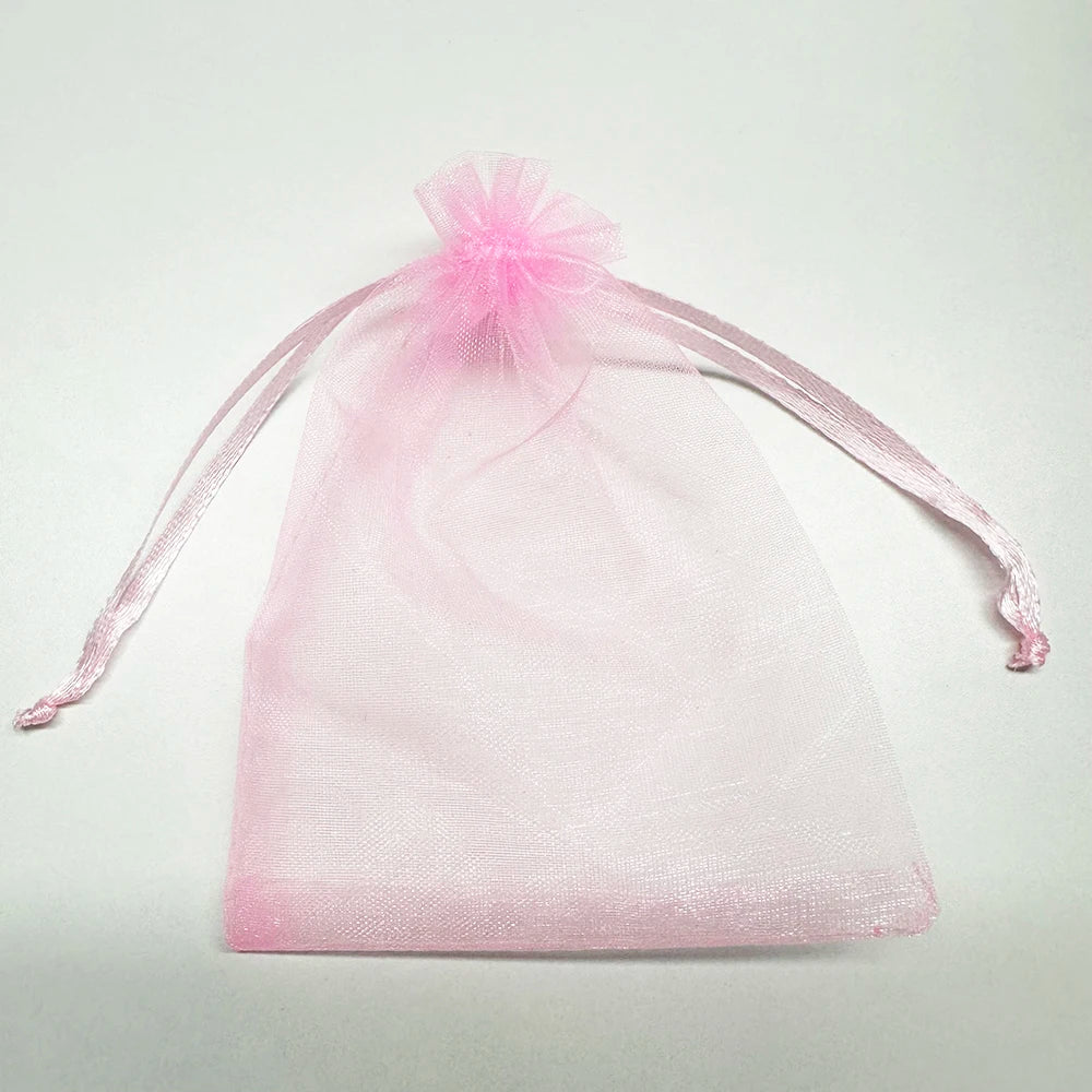 Pink organza drawstring bag with a sheer fabric tie and a decorative bow.