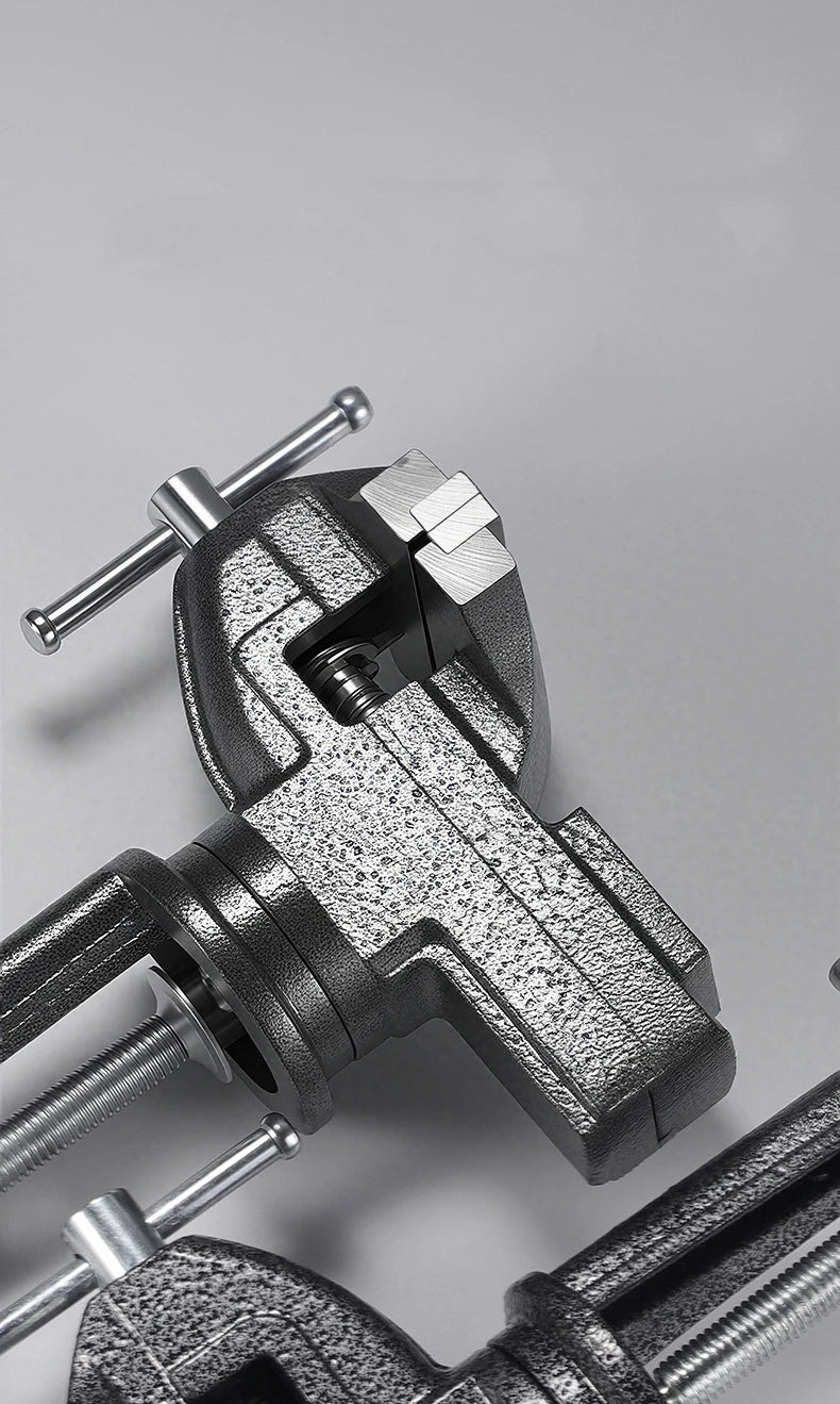 A close-up view of a gray clamp-on table vise with a swivel mechanism and mounting rods.