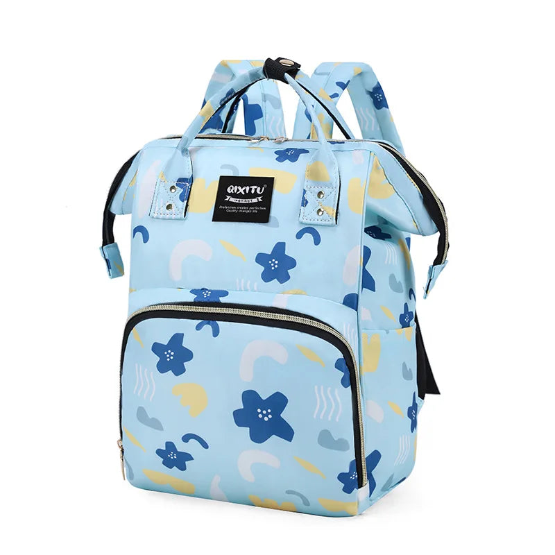 Light blue patterned backpack diaper bag with black straps and multiple pockets