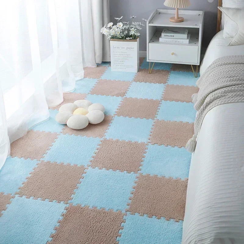 Light blue and beige interlocking plush floor tiles arranged in a grid pattern on a carpet.