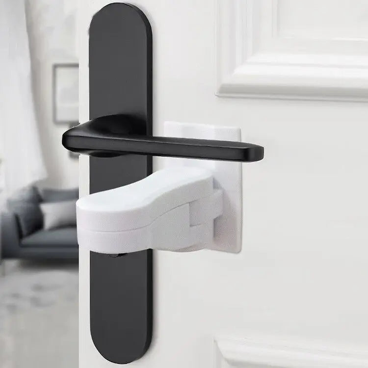 A close-up of a black and white door lever lock with an adhesive anti-open latch mechanism installed on a white door frame.