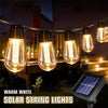 Warm white solar string lights hanging outdoors illuminating a wooden deck area at night