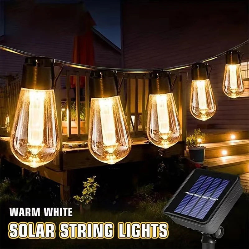 Warm white solar string lights hanging outdoors illuminating a wooden deck area at night