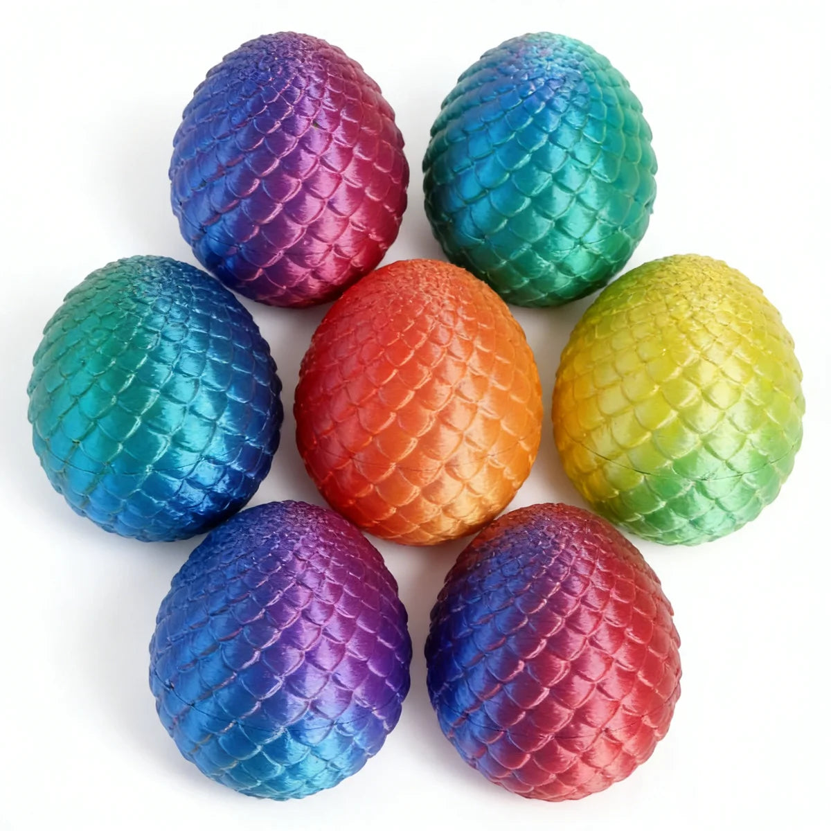 Six iridescent, textured eggs in various shades of blue, purple, green, and orange.