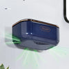 A dark blue, oval-shaped soap holder with a hollow design is mounted on a white wall.