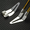 A pair of silver plastic welding repair pliers with gold-colored handles resting on a black textured surface.