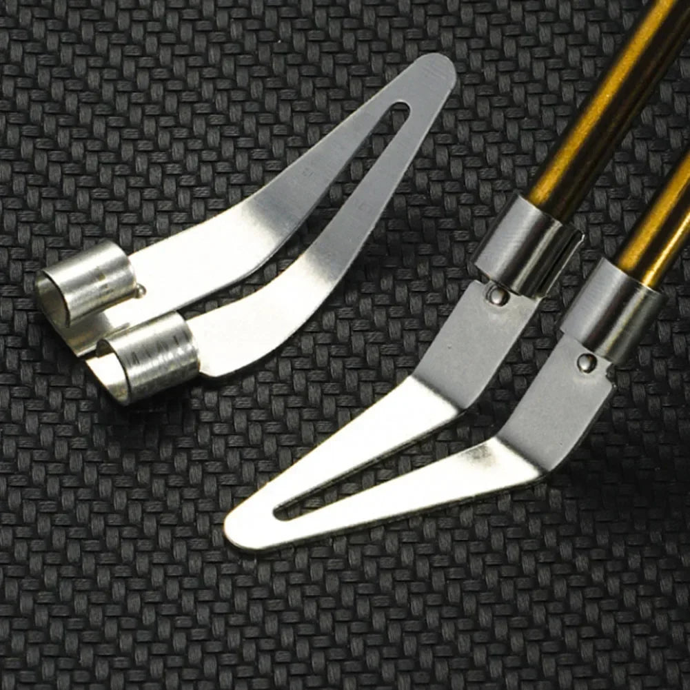 A pair of silver plastic welding repair pliers with gold-colored handles resting on a black textured surface.