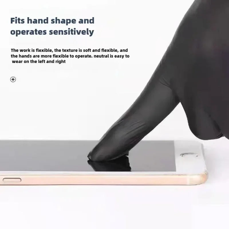 A hand wearing black nitrile disposable gloves is operating a silver tablet device.