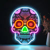A glowing neon light shaped like a skull with vibrant internal colors against a dark background.