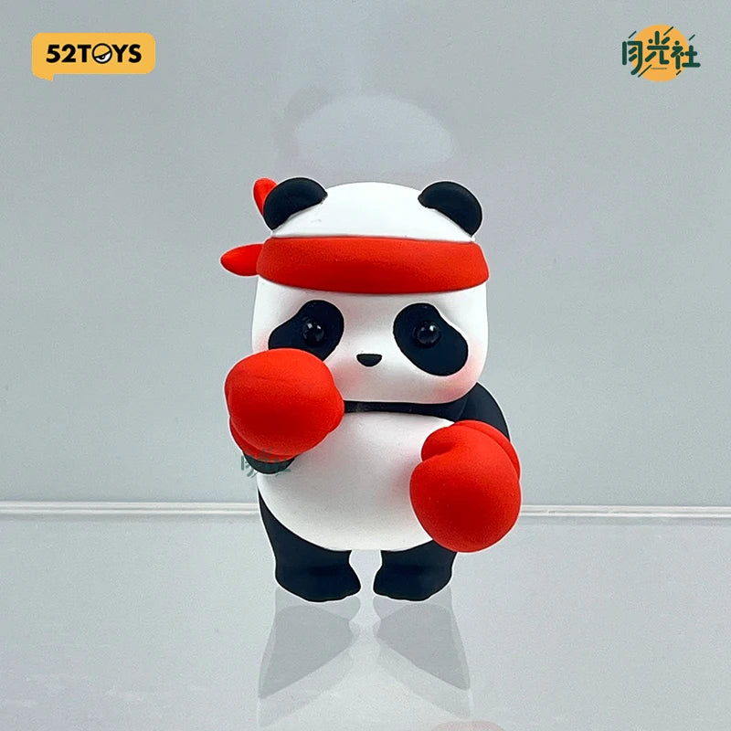 A white panda figure wearing an orange headband and holding red boxing gloves.