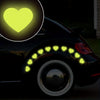 A black car features yellow heart stickers on the taillight and a glowing heart icon.