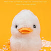 A white wind-up walking chicken toy with yellow feet is shown against an orange background.