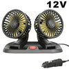 A black 12V car cooling fan with dual heads and an aromatherapy diffuser resting on a base.