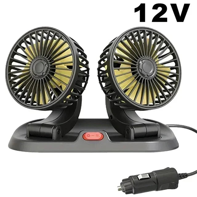 A black 12V car cooling fan with dual heads and an aromatherapy diffuser resting on a base.