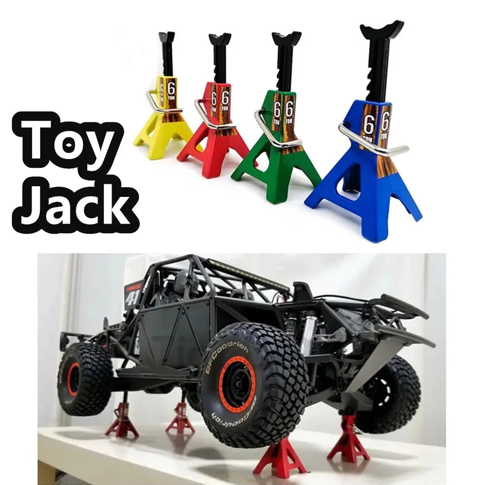 A set of six 6-ton metal jack stands in various colors are displayed next to a black RC car with four large tires.