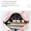 A pink travel duffel bag is open, showing organized compartments for various items like electronics and clothing.