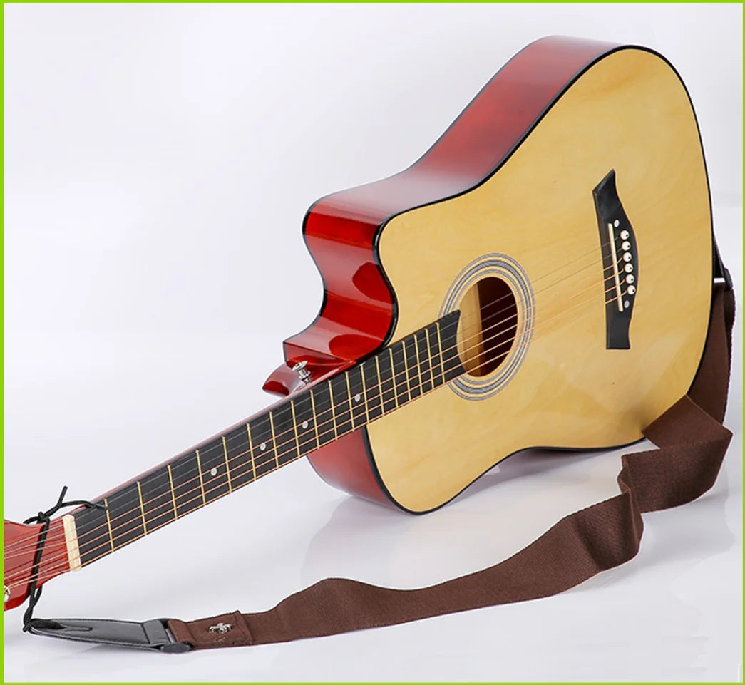 A vintage acoustic guitar with a sunburst finish and a brown strap is shown.