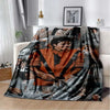 A dark flannel throw blanket featuring a collage of black and white photographs, including images of Michael Jackson.