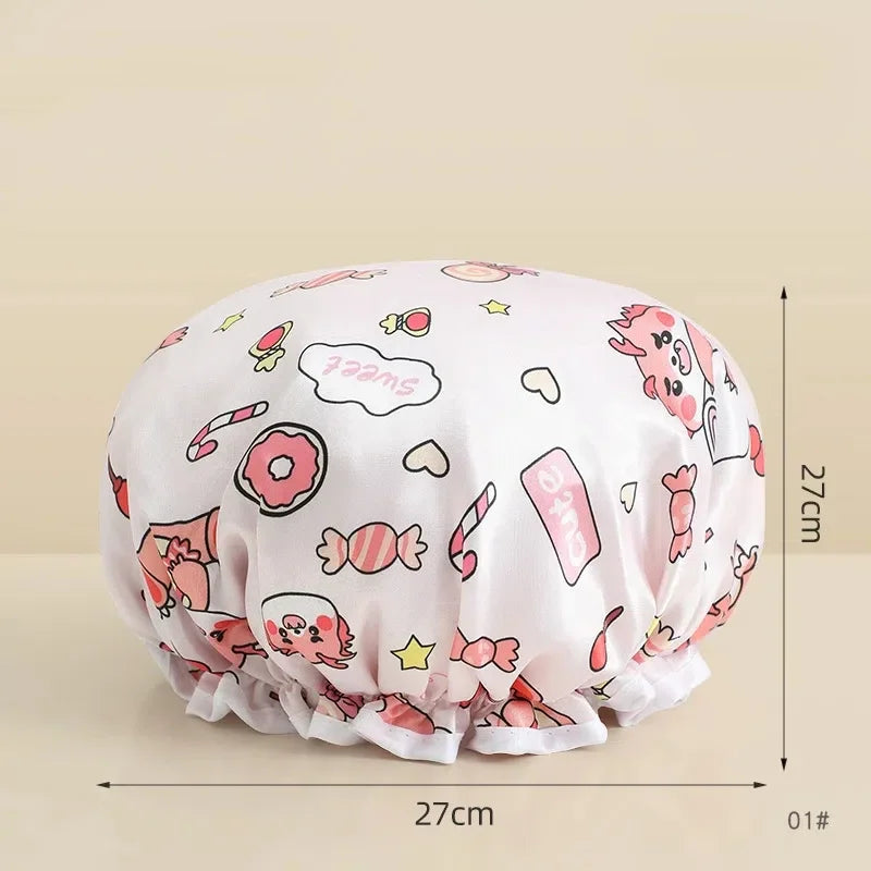A pink and white reusable waterproof shower cap for hair care shown from above.