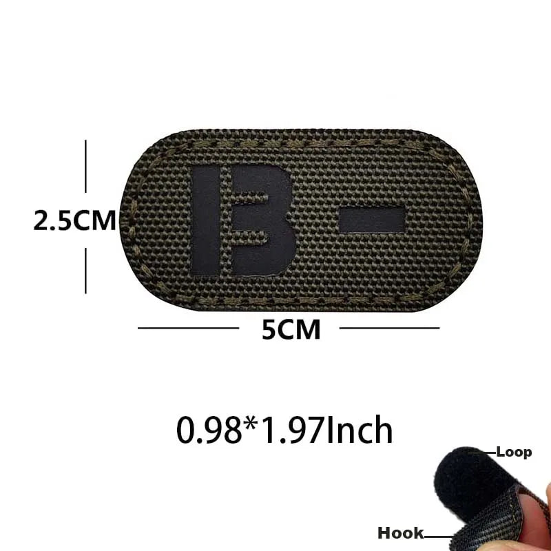 A dark olive green glow-in-the-dark blood type tactical patch with a hook and loop backing.