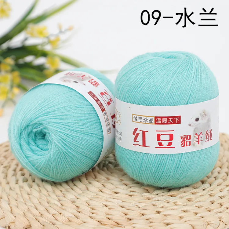 A ball of light turquoise yarn labeled 09-水兰三 for knitting and crochet
