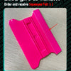 A bright pink magnetic squeegee tool is shown on a light surface.