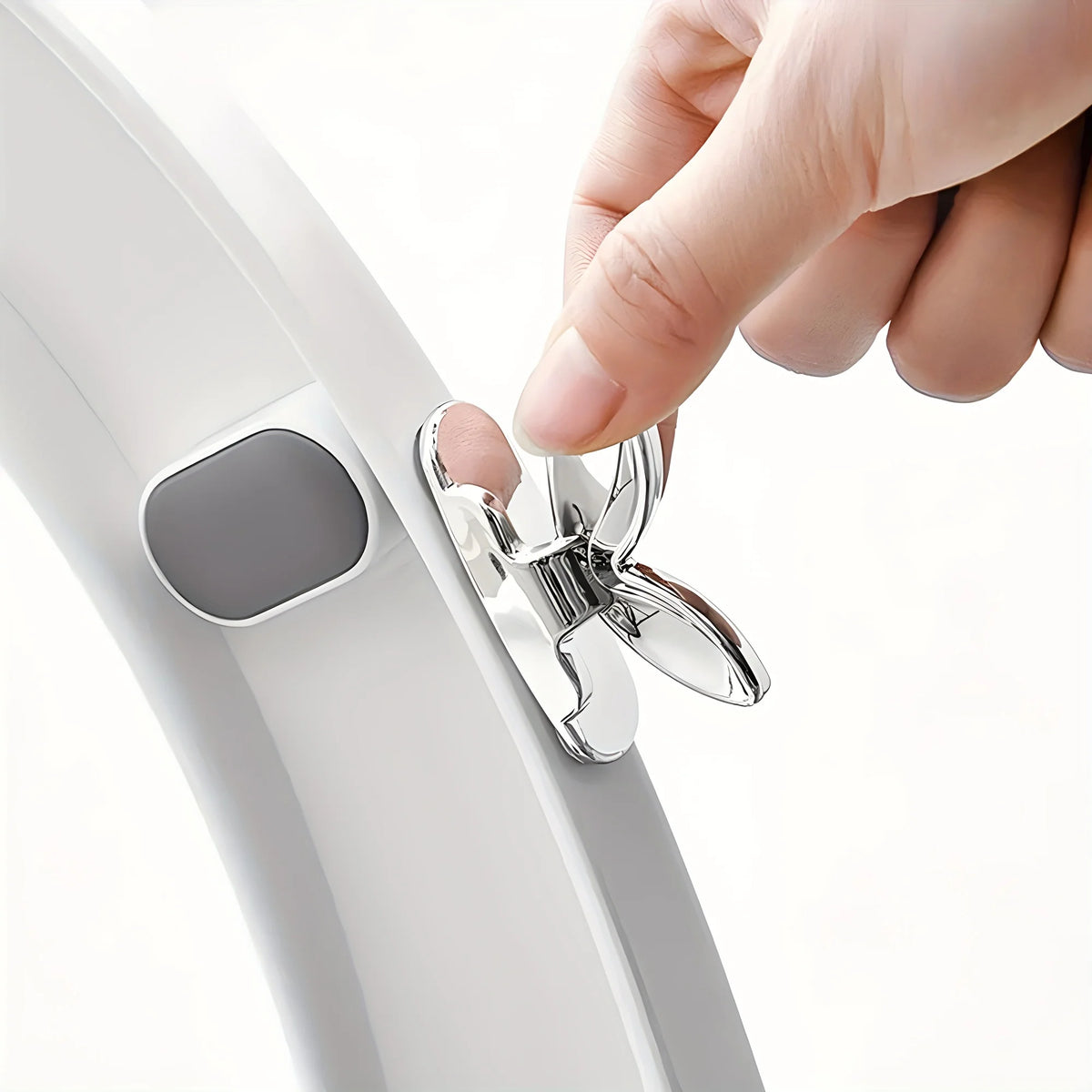 A hand is lifting a toilet seat using the flush button mechanism on a white toilet.