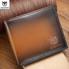 A brown genuine leather bifold wallet with a subtle bull emblem resting on a wooden surface.
