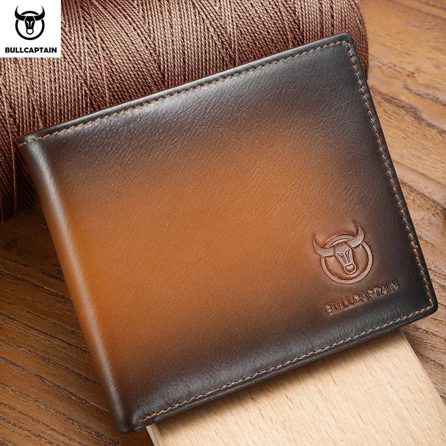 A brown genuine leather bifold wallet with a subtle bull emblem resting on a wooden surface.