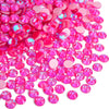 A pile of bright pink and magenta rhinestones for DIY crafts and clothing decoration