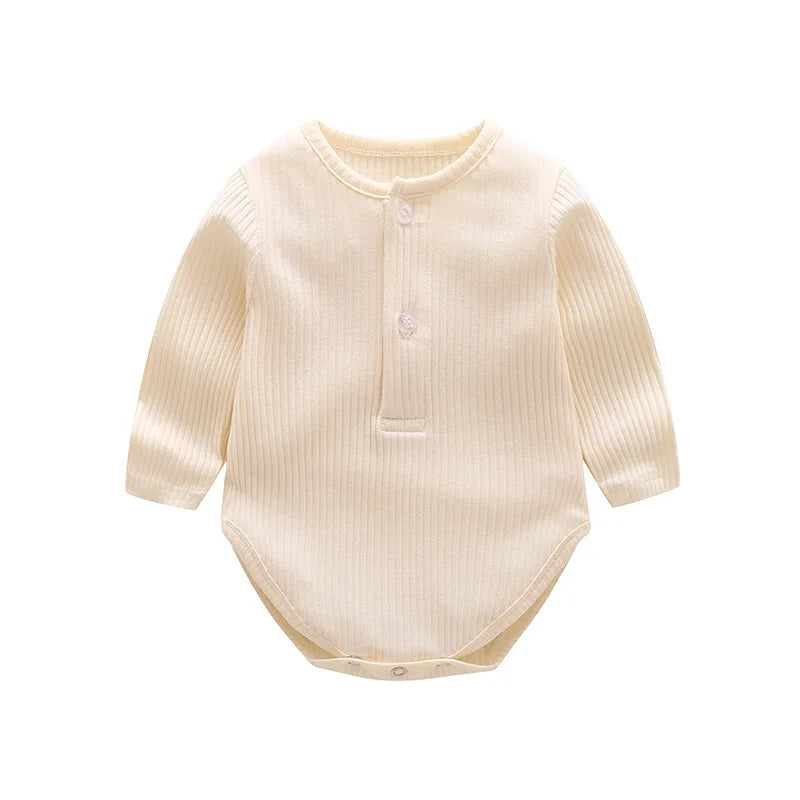 A cream-colored long-sleeved cotton romper for a baby girl with a button placket.