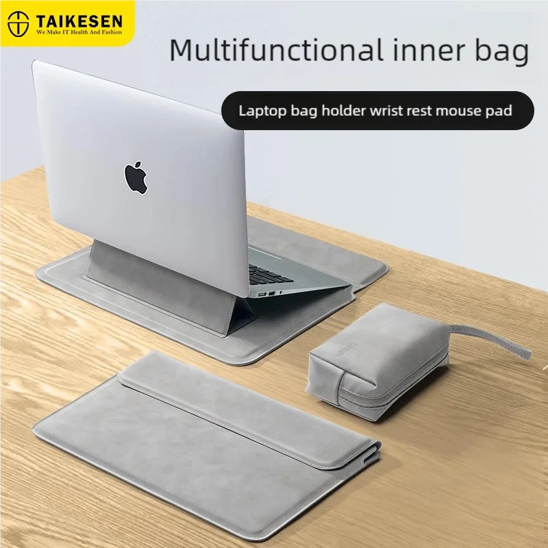 A gray multifunctional inner bag used as a laptop bag holder and wrist rest mouse pad under an Apple laptop.