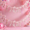 Pink sheer ribbon bow knot banner garland decorating a pink background for events