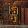 A set of books and a decorative wooden object displayed next to a box featuring a scene from The Detective House book.