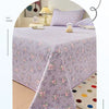 A lilac floral quilted bedspread draped on a bed, emphasizing its dust-proof feature.