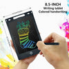 An 8.5-inch LCD writing tablet showing a colorful drawing of a Christmas stocking and tree, held by a hand.