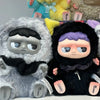 A pair of MONBOO Emotional Weather Station collectible blind box figures featuring gray and black furry characters.