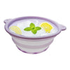 A purple silicone bowl filled with ice cubes, a slice of lemon, and a mint leaf for facial massage.